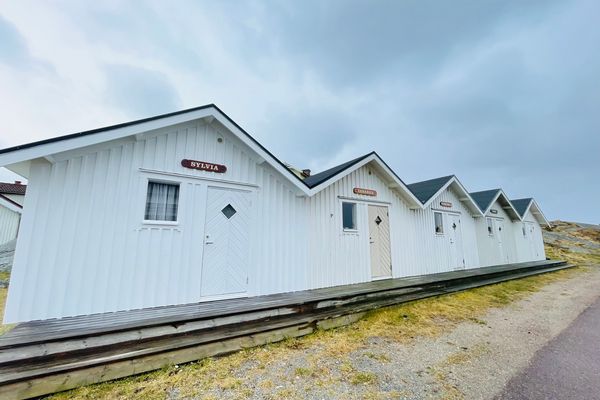 A view of red wooden houses on Vrango Archipelago island .